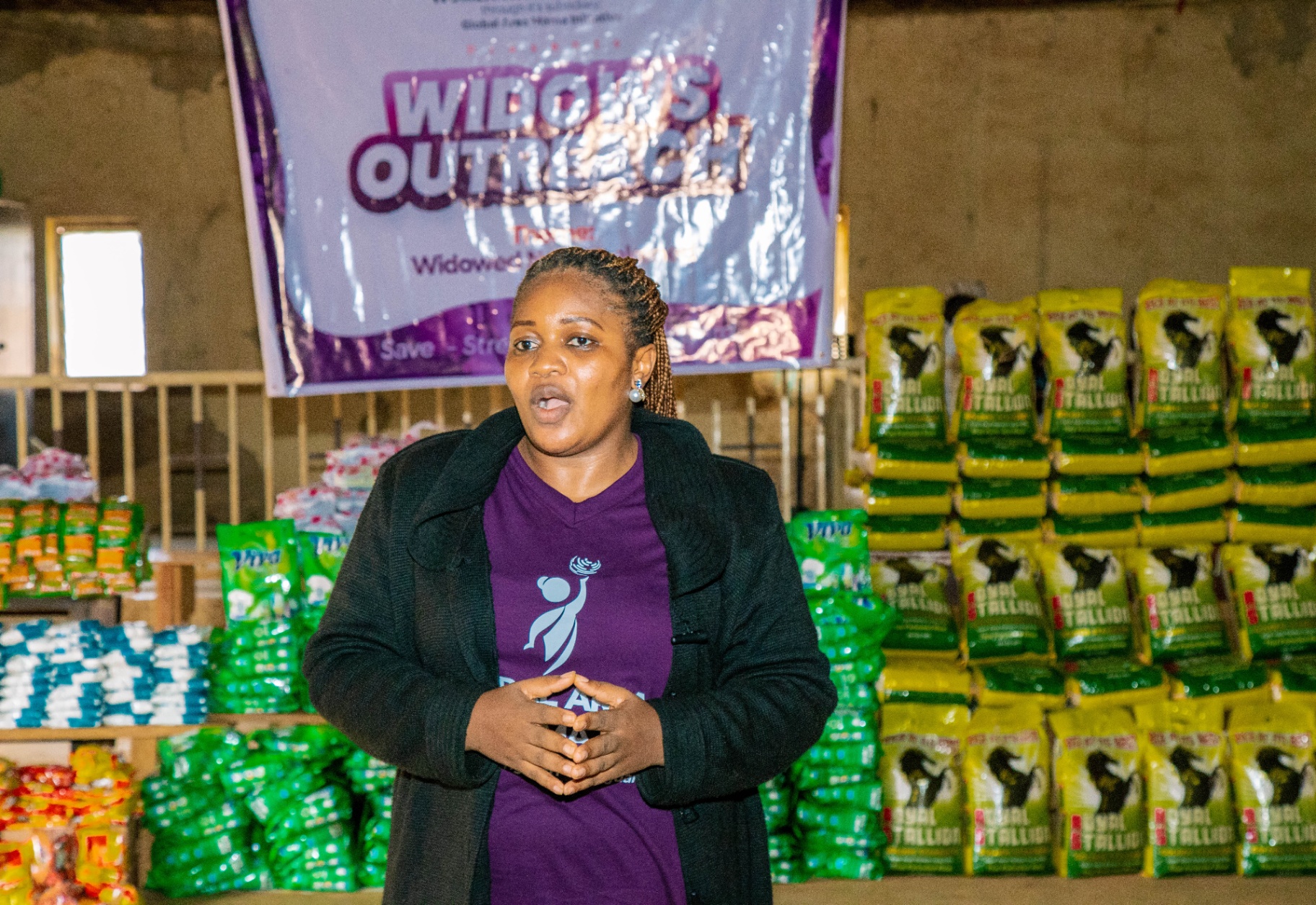 Team member addressing widows during the outreach